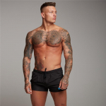 Muscleguys meeste pehmed ja siledad rannap&uuml;ksid J&otilde;usaali Fitness dressipluusid Kulturismi elastne v&ouml;&ouml;koht Prindiga p&uuml;ksid &otilde;hukesed vabaaja p&uuml;hadep&uuml;ksid M must