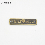 50 tk Vintage k&auml;sitsi valmistatud kirjariided metallist sildid Kaunistus DIY teppimine Naiste kotid Sildid Aksessuaarid Tarvikud pronksi