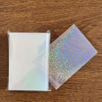 50 tk/partii L&auml;bipaistvad kaardi&uuml;mbrised 5,7x8,6 cm Little Stars Laser Flashing Card Sleeve Kaitsekaartide hoidik Kaitsekile 65*90mm