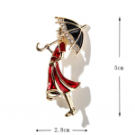 Emailitud t&uuml;druk, kes kannab vihmavarju kaelarihma, prossi n&ouml;&ouml;pn&otilde;elaga ehteid