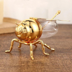 Luksuslik mesilaste meepott mee s&auml;ilituspurk Dekoratiivne ornament Mesilaspurk l&auml;bipaistev maitseainepurk K&ouml;&ouml;gi maitseainepurk lusikaga kuld